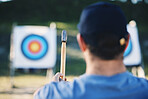 Sports, archery and man with axe for target on range for training, exercise and hunting competition. Extreme sport, bullseye and male archer aim with tomahawk weapon for practice, games and adventure