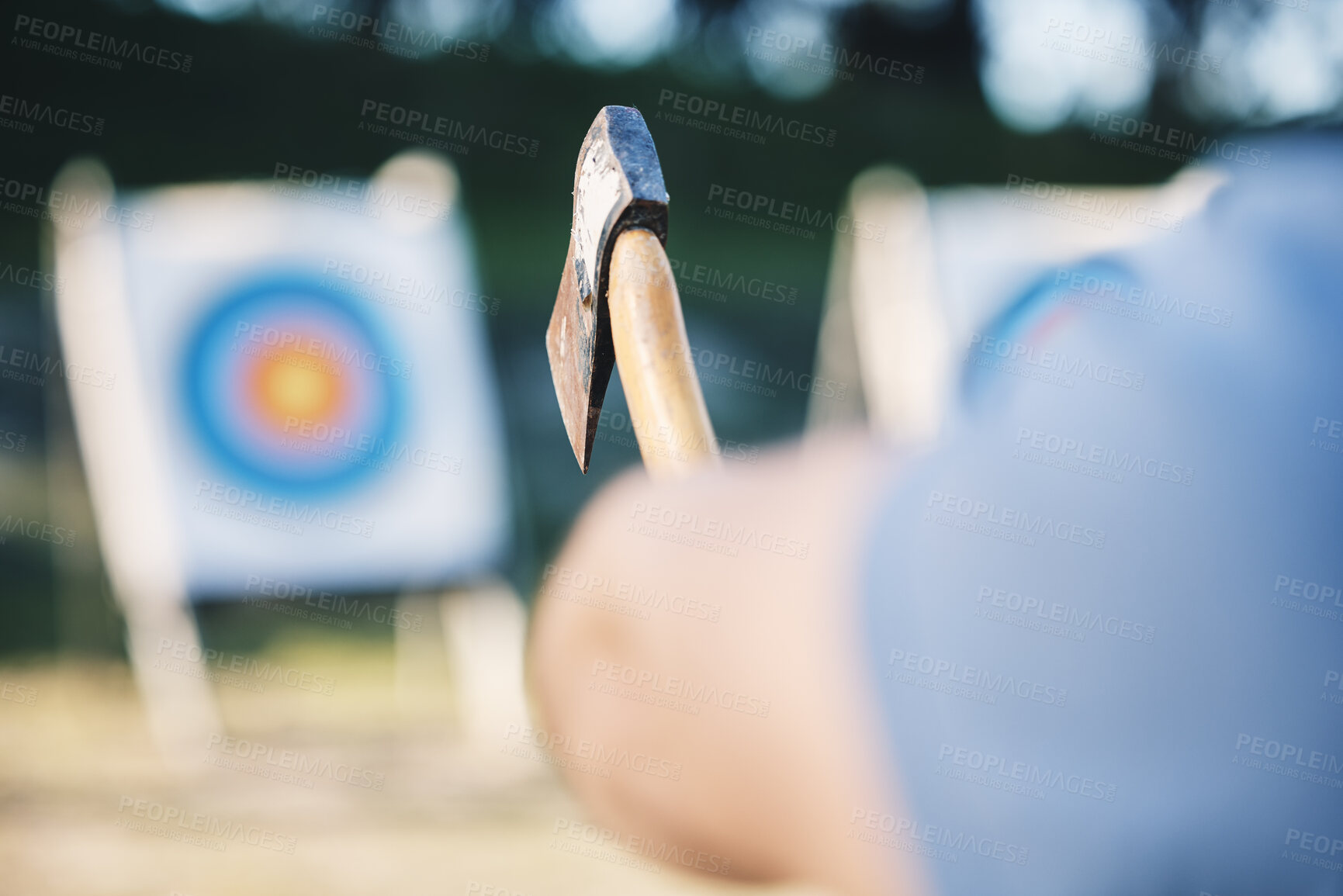 Buy stock photo Man throwing axe at sports range, archery training or practice with board circle for goal, game and exercise. Strong person closeup with weapon for tomahawk competition, gaming park and eye target