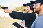Gun range, target practice and woman holding a rifle for safety, security and police training. Field, exercise, and learning to fire at a outdoor academy with mentor and shooting gear for challenge 