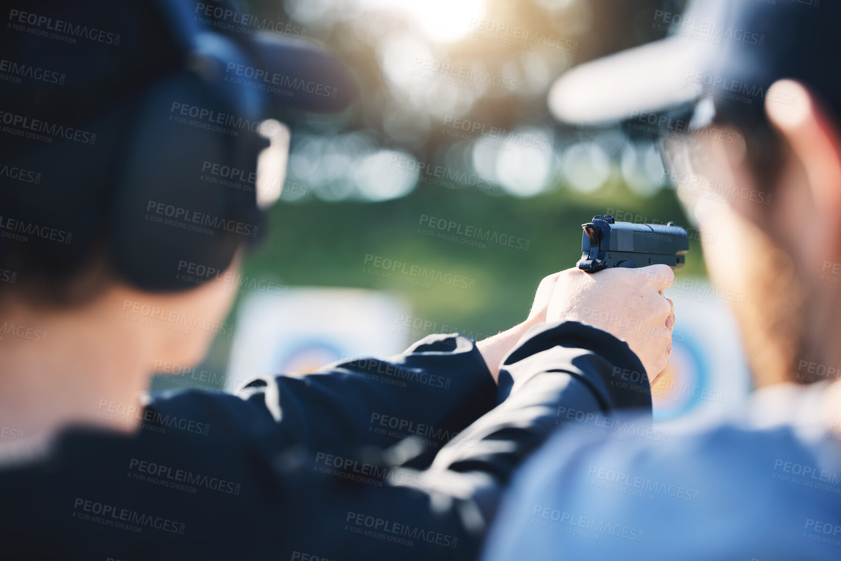 Buy stock photo Man, woman and gun training with target, outdoor challenge and aim at police, army or security academy. Shooting coach, pistol or firearm for sport, safety and combat exercise in nature with vision