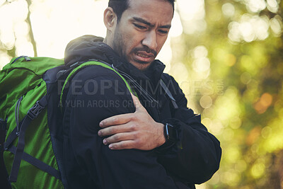 Buy stock photo Man, shoulder pain and hiking in forest, nature or woods with muscle crisis, anatomy problem or fitness accident. Medical, arm and injury emergency for athlete, backpacking hiker or healthcare stress