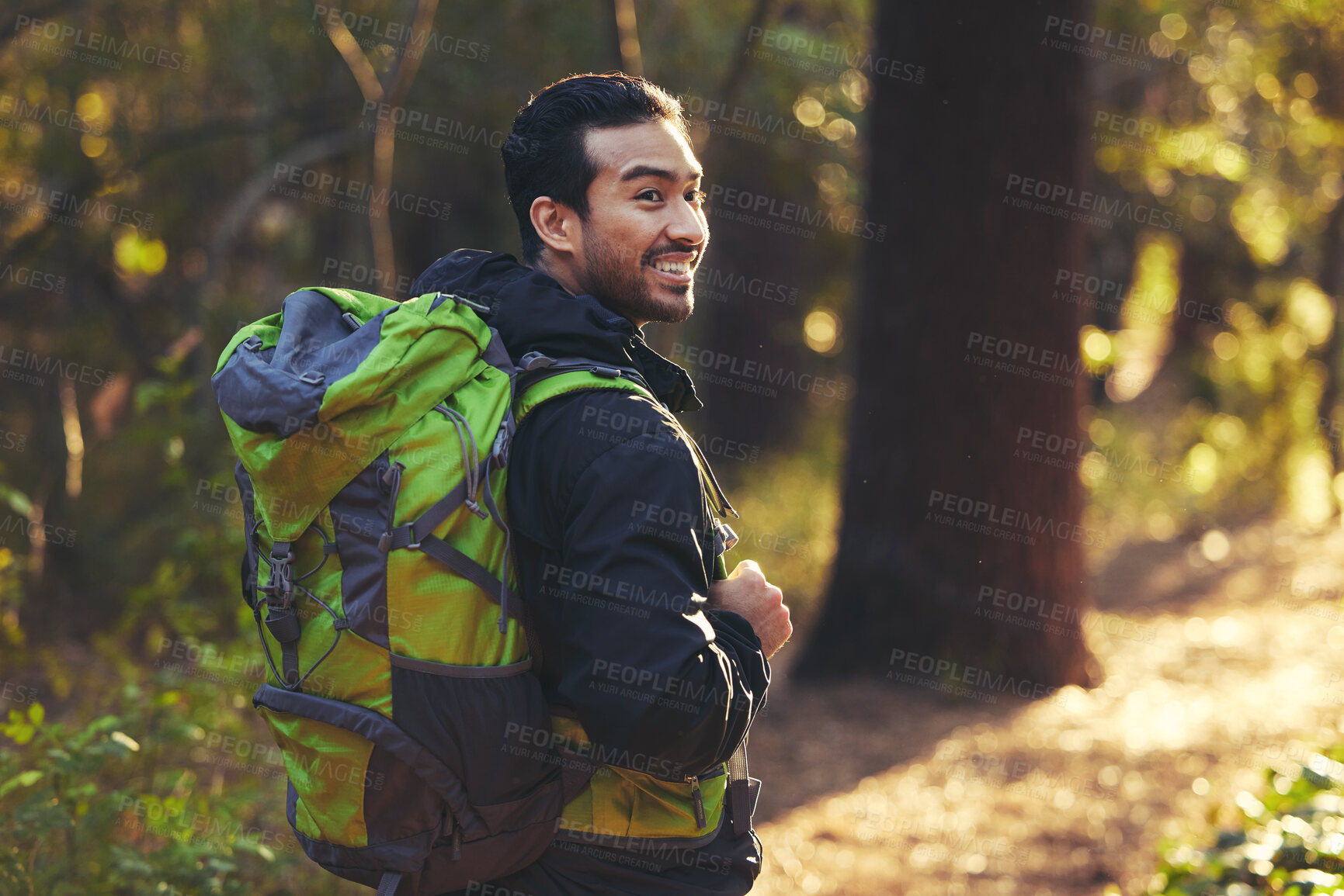 Buy stock photo Japanese man, backpacker and hiking in forest nature, trekking woods or trees for adventure, relax workout or fitness exercise. Smile, happy and hiker walking in environment for healthcare wellness