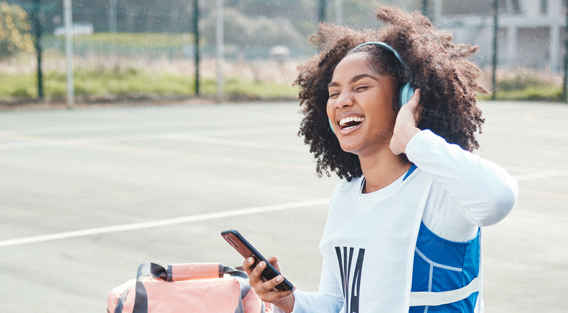 Buy stock photo Netball sports, smartphone music or happy woman listen to mp3 radio, audio podcast or media song after fitness training. Relax wellness, digital headphones or African athlete streaming sound on court