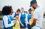 Team, soccer and women football coach at training, fitness and workout on the field or sport ground for practice. Match, game and female athletes with trainer at stadium with players as teamwork 