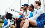 Court, netball and coach with women pointing on stand watching game, match and practice on court. Coaching, teamwork and female athletes show support, motivation and instruction for sport competition