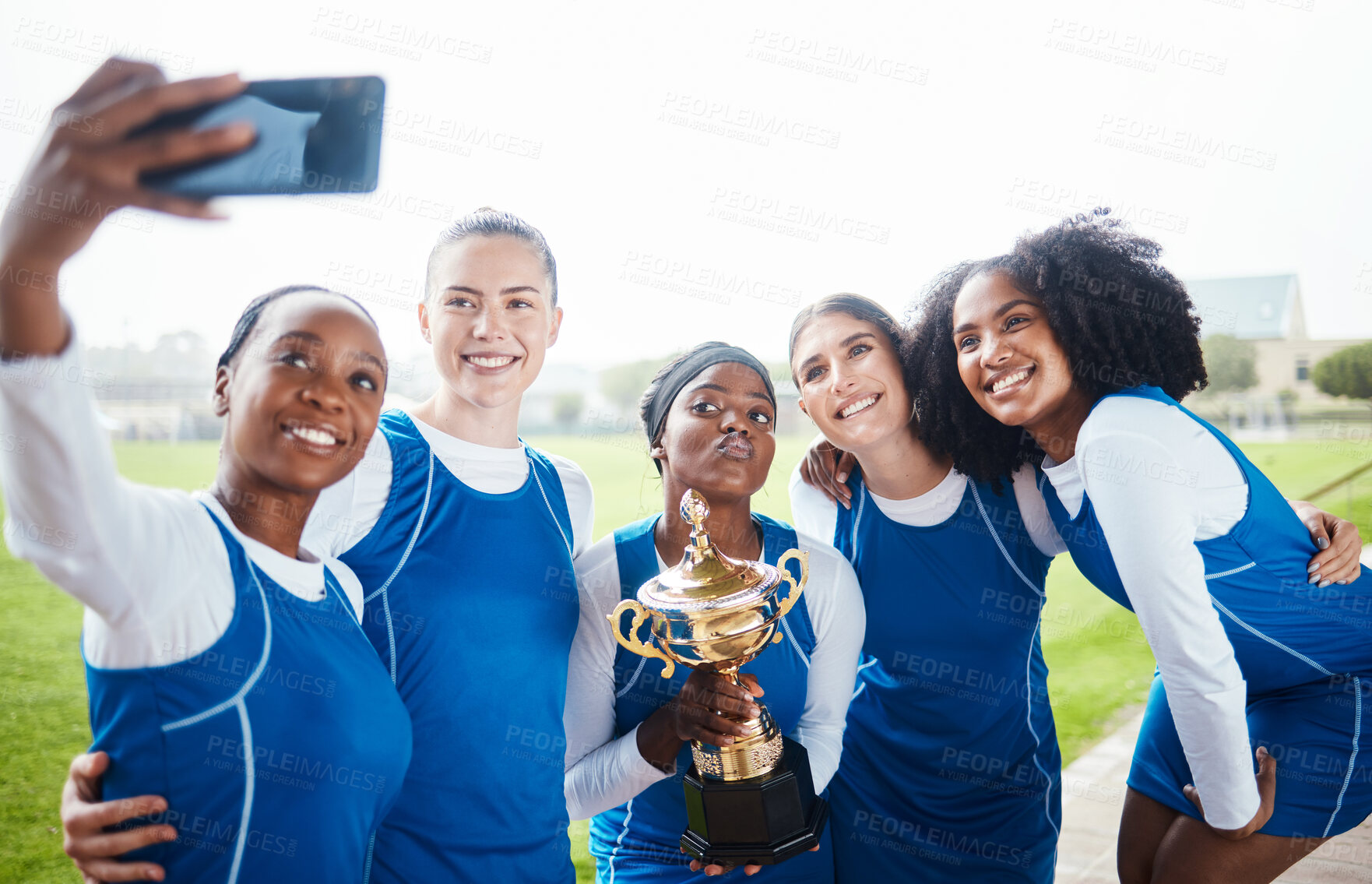 Buy stock photo Black woman, friends and celebration in selfie, winning trophy or sports team on grass field outdoors. Happy sporty women smiling for photo or celebrating netball win, victory or achievement together