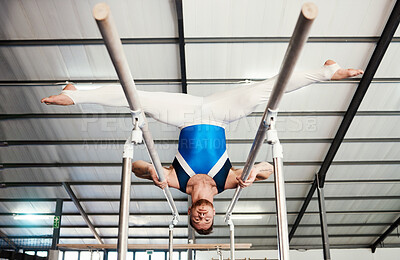 Buy stock photo Gymnast man, bars and exercise with balance, strong body and focus for sports, vision and split legs in air. Gymnastics, athlete and training with muscle development, workout and low angle at gym