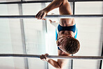 Gymnastics man, bars and exercise with balance, strong body and focus for sports, vision and professional career. Gymnast, athlete and training with muscle development, workout and low angle at gym