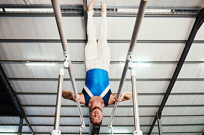 Buy stock photo Man, gymnast and upside down on poles in fitness for practice, training or workout at gym. Professional male acrobat in gymnastics holding body weight up on rail for athletics or strength exercise