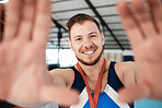 Gymnastics, sports and man athlete taking a selfie after winning a medal in a competition. Happy, smile and portrait of proud male gymnast winner taking a picture after training or practice in arena.