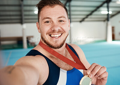 Buy stock photo Gymnastics, fitness and male athlete taking a selfie after winning a medal in competition. Sports, smile and portrait of happy male gymnast winner taking a picture after training or practice in arena