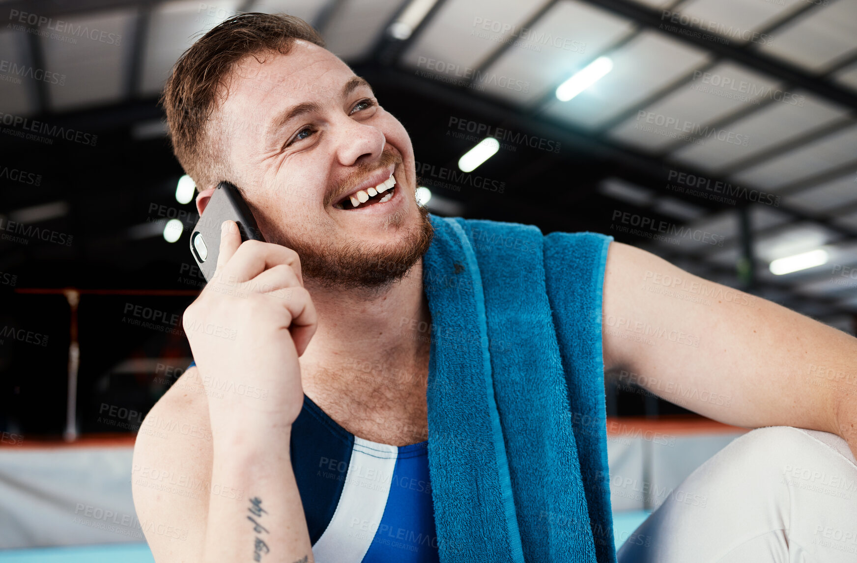 Buy stock photo Phone call, sports and man relaxing after training, workout or competition in arena or studio. Fitness, gymnastics and happy male athlete gymnast with a smile on a mobile conversation after practice.