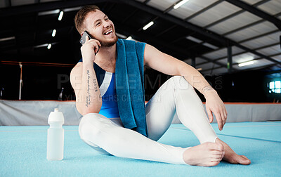 Buy stock photo Phone call, fitness and male relaxing after training, workout or competition in arena or studio. Sports, gymnastics and happy man athlete gymnast with a smile on a mobile conversation after practice.