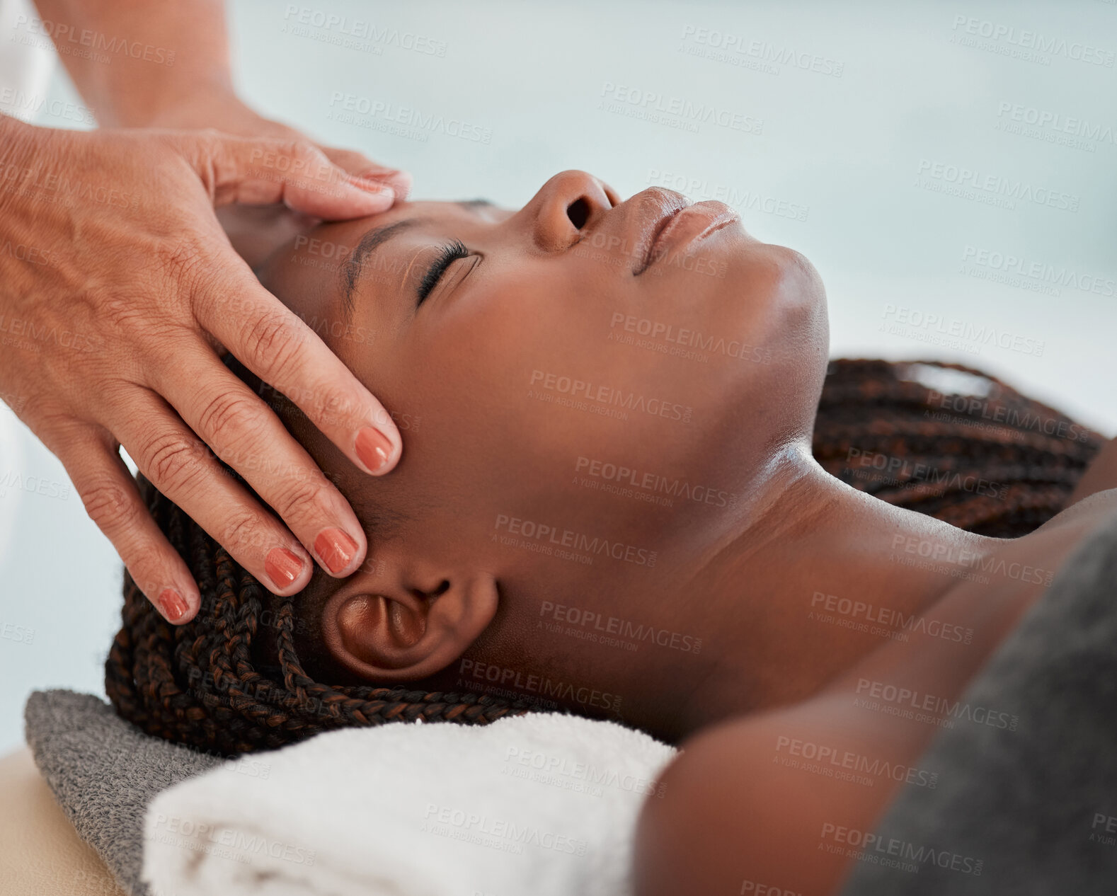 Buy stock photo Facial massage, spa and black woman with skincare wellness, peace and calm for luxury treatment. Relax face or head of person and therapist hands for beauty, zen and healing, stress relief on table