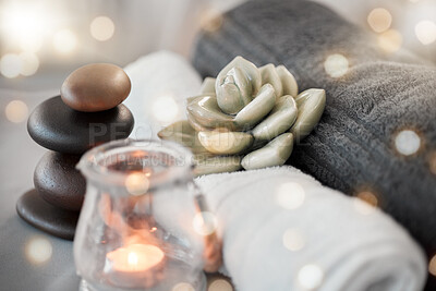 Buy stock photo Rock, candle and towel in a spa for zen to relax in a stress free empty room with aromatherapy ambience. Luxury, salon and wellness with still life objects in an interior for relaxing stress relief
