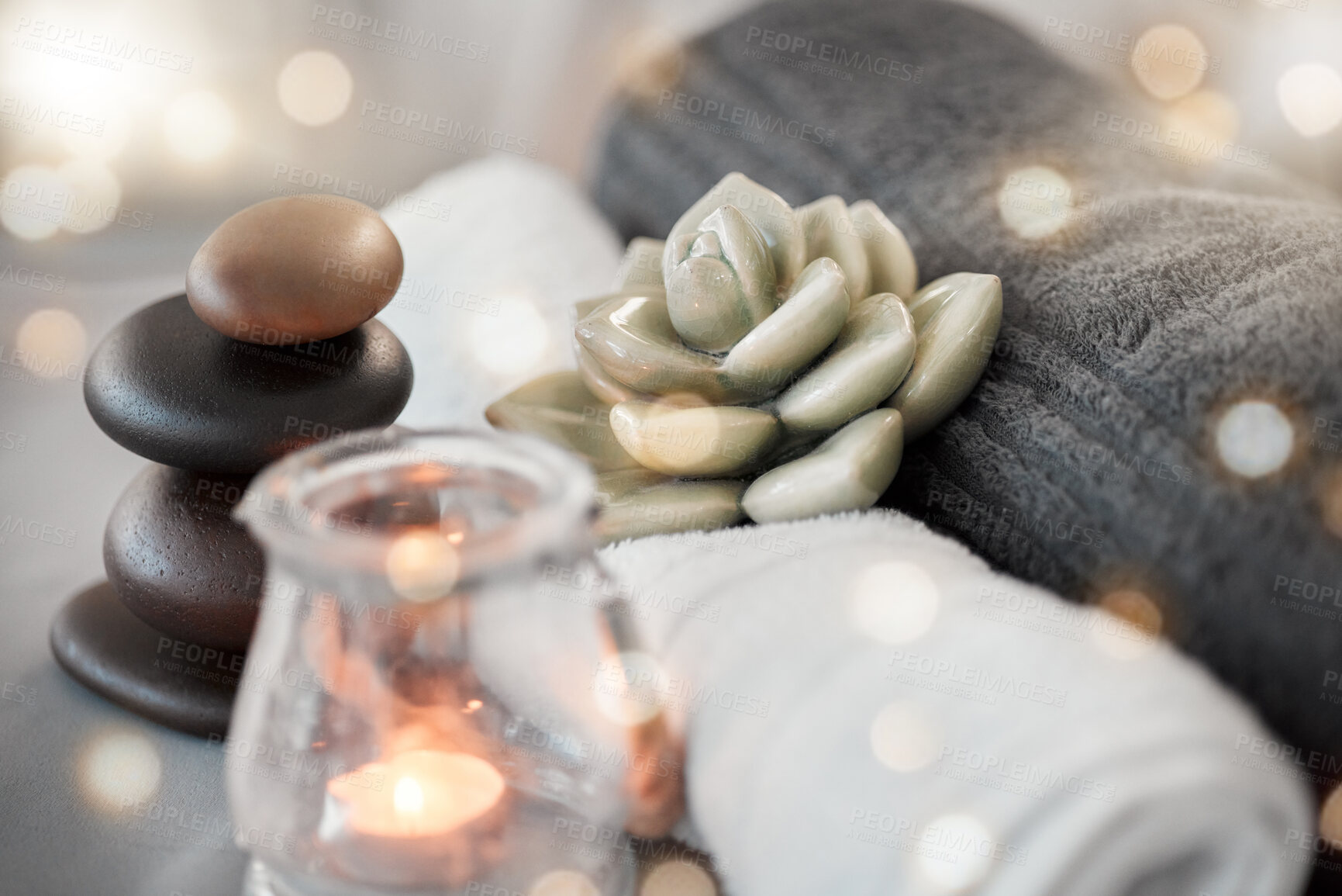 Buy stock photo Rock, candle and towel in a spa for zen to relax in a stress free empty room with aromatherapy ambience. Luxury, salon and wellness with still life objects in an interior for relaxing stress relief