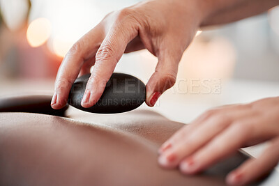 Buy stock photo Hot stone massage, spa and hands of masseuse, holistic care and wellness with physical therapy and treatment. Health, peace of mind and self care with zen, stress relief people and back skin detox