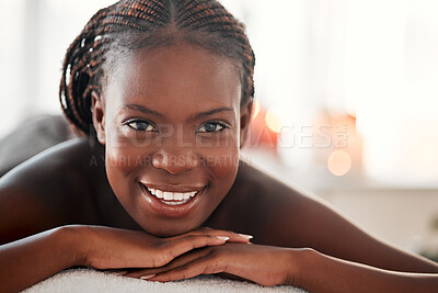 Buy stock photo Spa, portrait and black woman with smile, massage and salon luxury treatment, bare and lying on table. Face, African American female and lady with happiness, relax and healing therapy for wellness