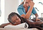 Black woman, bed and smile for back massage, spa treatment or relaxation in stress relief at resort. Happy African American female relaxing with masseuse massaging with elbow for physical therapy