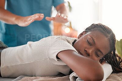Buy stock photo Relax, reiki and black woman on bed with eyes closed at spa for chakra therapy and holistic medicine. Spiritual healing, balance and zen, person with peaceful and healthy mind at traditional massage.