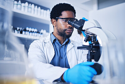 Microscope, science and black man working on study in laboratory for medical research analysis. Scientist, microbiology and biotechnology worker check investigation, innovation and dna pathology test