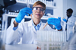 Glass vials, scientist and mature woman doing research, experiment or tests in a medical lab. Innovation, professional and senior female scientific researcher working in a pharmaceutical laboratory.