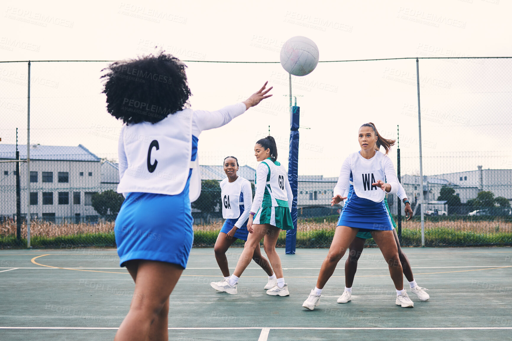 Buy stock photo Fitness, sports and netball match by women at outdoor court for training, workout and practice. Exercise, students and girl team with ball for competition, speed and performance while active at field