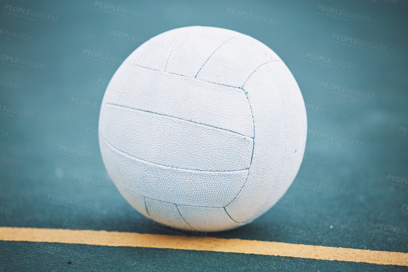 Buy stock photo Netball on the floor on a sport court for a game, training or exercise outdoor on a field. Sports, fitness and white ball on the ground for a match, workout or practice competition by a outside arena