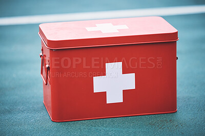 Buy stock photo First aid, kit and health equipment for medical emergency, response and treatment kit isolated on a blurred background. Red, cross and medicine on a sports ground or court for fast health or cure  