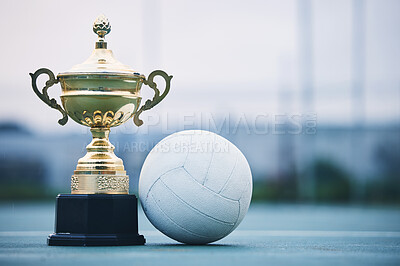 Buy stock photo Gold, winner and sports with trophy and netball for achievement, award and championship. Celebration, fitness and victory with prize and ball on ground of court for event, competition and success