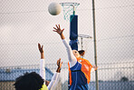 Netball, goal shooting and defense of a girl athlete group on an outdoor sports court. Aim, sport game and match challenge of a black person with a ball doing exercise and training in a competition