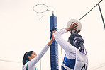 Sports, netball and black woman shooting ball in match for competition, exercise or practice. Training, wellness or players playing game for workout, exercising or competitive performance outdoors.