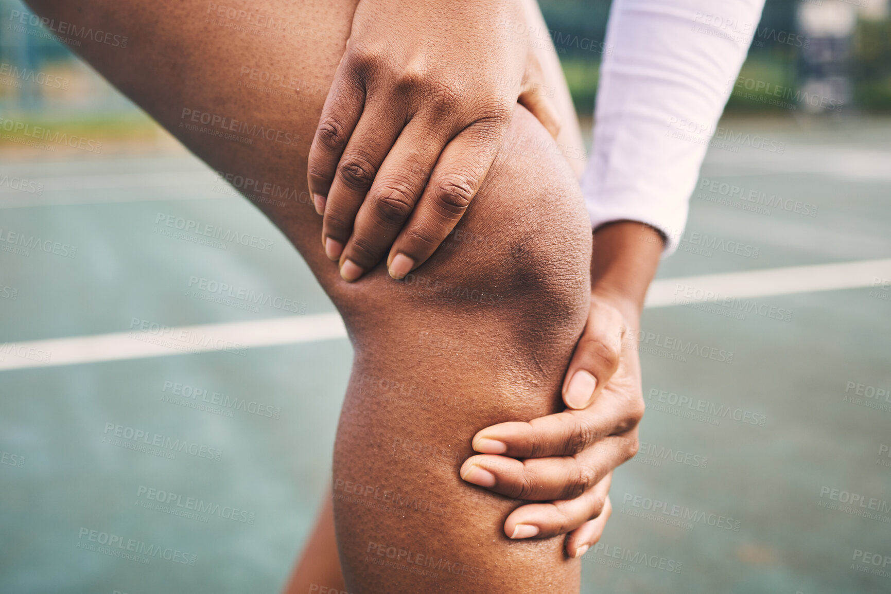 Buy stock photo Knee injury, sport pain and netball athlete on a outdoor sports court with joint or muscle problem. Training, exercise and black woman hands holding legs with muscle and wellness issue from run
