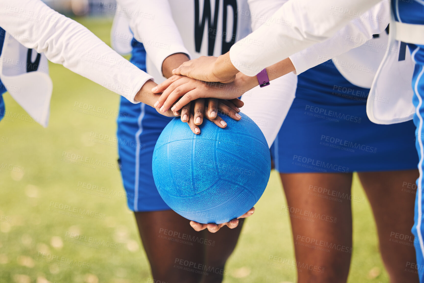 Buy stock photo Sports, netball and team in a huddle with a ball for game strategy planning, motivation or pride. Fitness, diversity and female athletes with a stack of hands for collaboration on field before match.