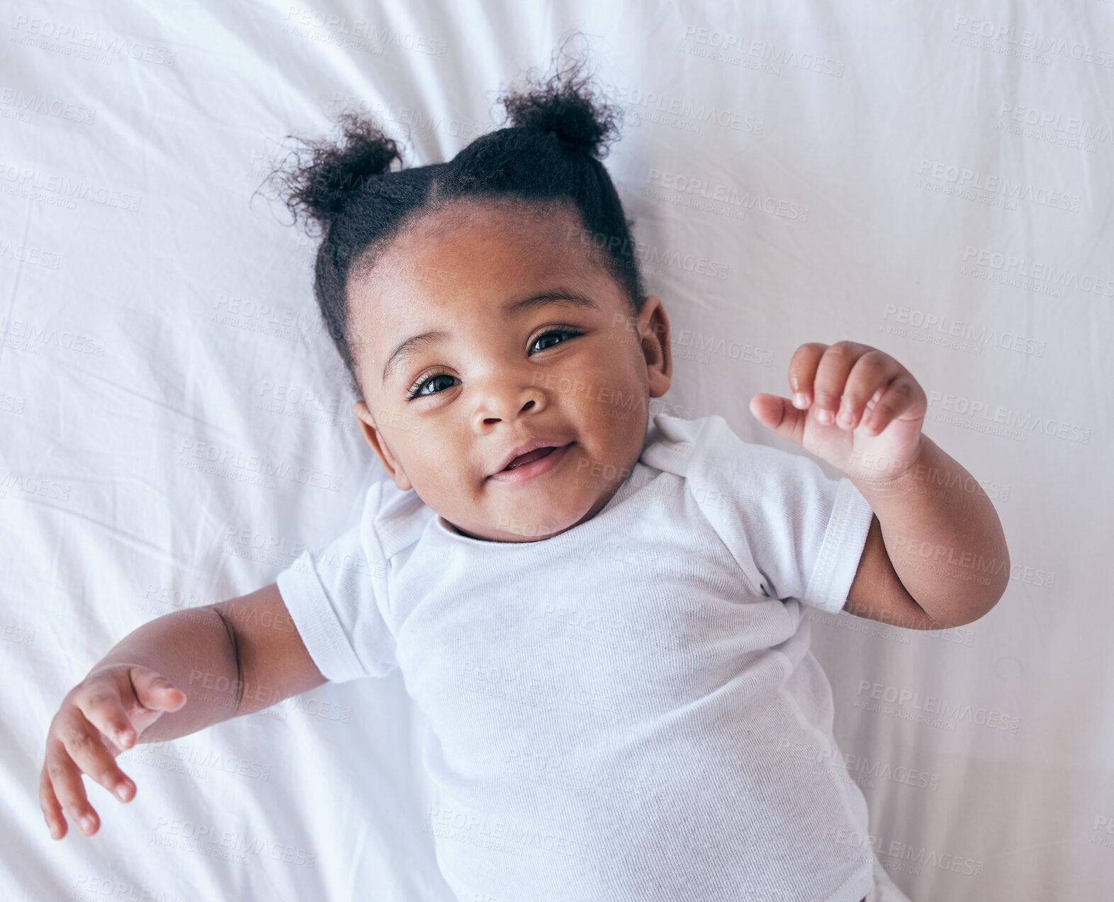 Buy stock photo Above, portrait and baby relax in bed, happy and content after waking up in her home. Face, toddler and girl smile in a bedroom, lying and playing, curious and sweet on a peaceful morning in nursery