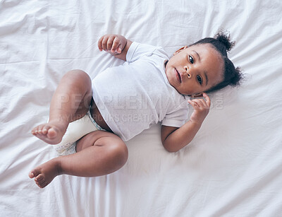 Buy stock photo Baby, portrait and girl on a bedroom bed feeling relax and calm in a nursery after rest. Young newborn, child and kid with a diaper in the morning with wellbeing and childcare from above in a house