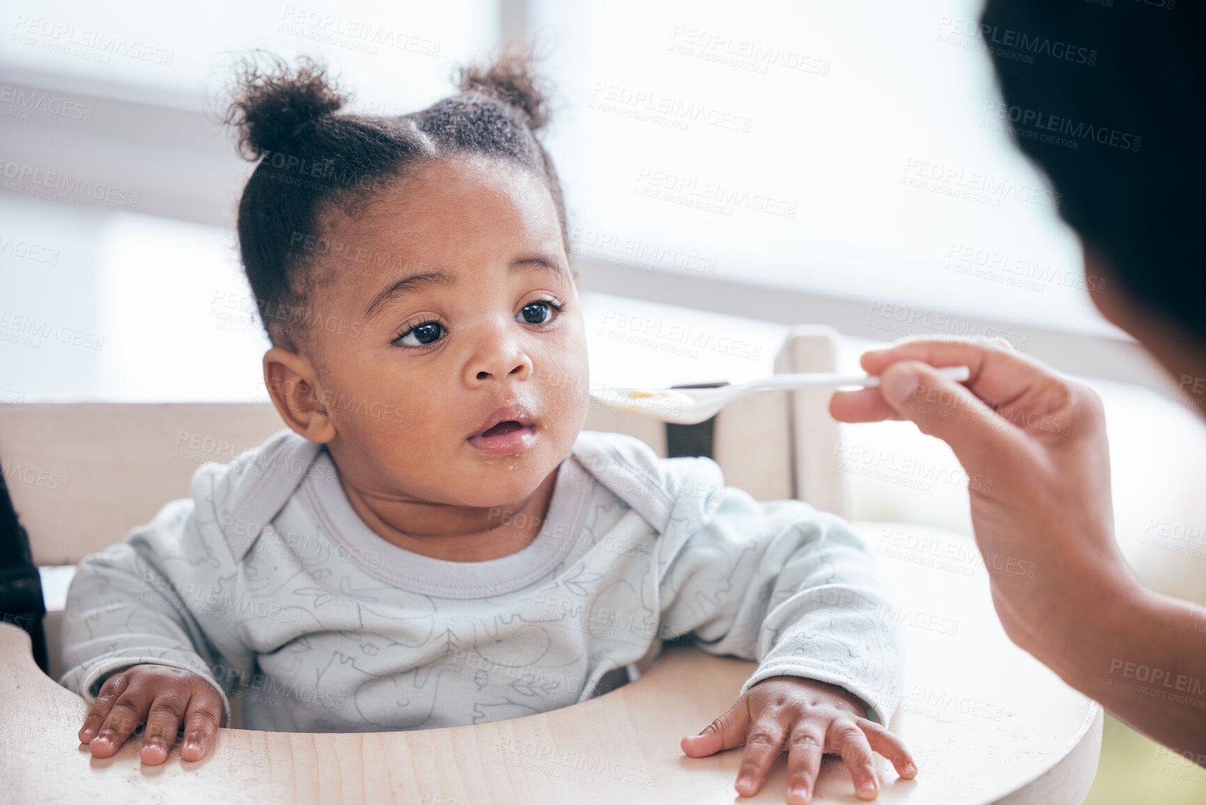 Buy stock photo Food, breakfast and parent feeding a baby in the morning while eating porridge with a mother. Hungry, feed and African child ready to eat a meal, lunch or dinner with a mom  in a family home