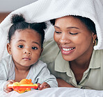 Baby portrait, black woman and mother love under a bedroom blanket on a bed with happiness. Smile, parent support and care with girl and children toy in a home with bonding together and a smile