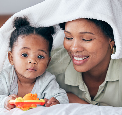 Buy stock photo Baby, mother and love under a bedroom blanket on a bed with happiness of black woman. Relax, parent support and care with portrait of girl and children toy in a home with bonding together and a smile