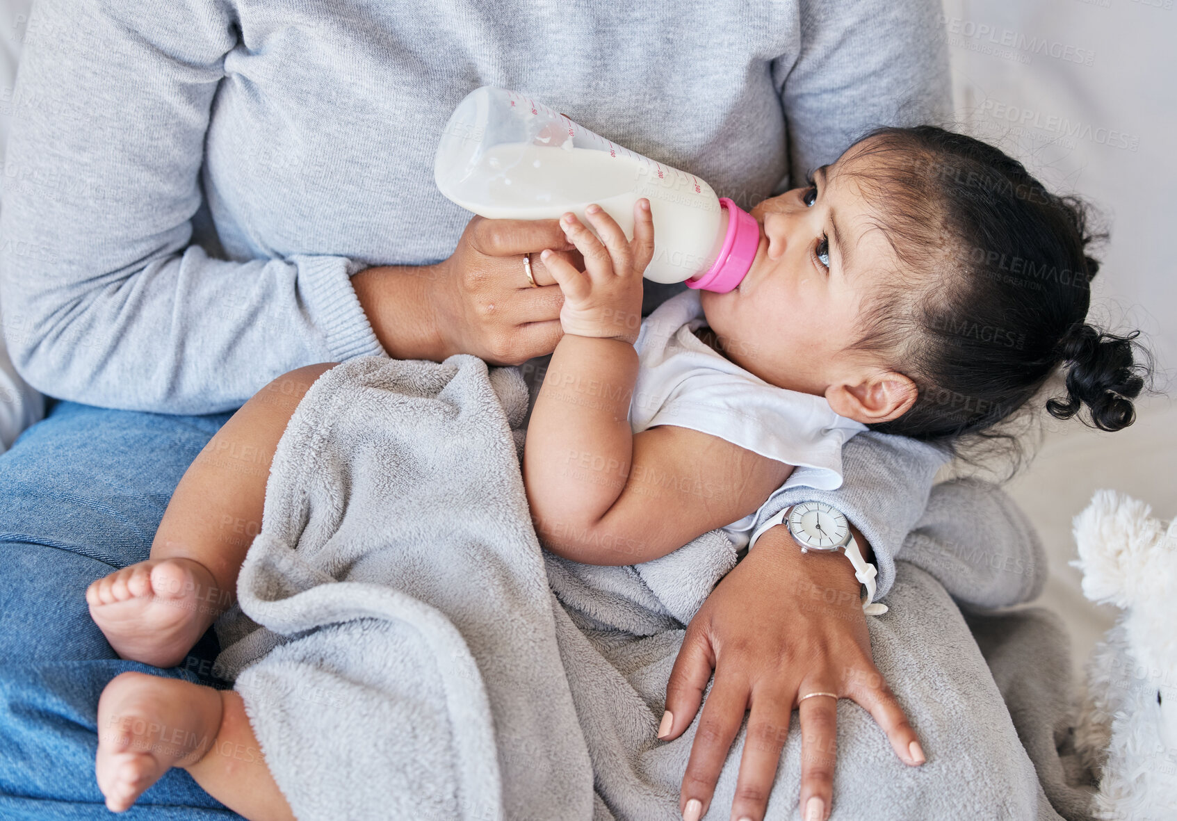 Buy stock photo Mom feeding baby, milk formula and nutrition with drinking, family and healthy, growth and childhood development. Woman feed infant child at home, meal and hands with health and wellness