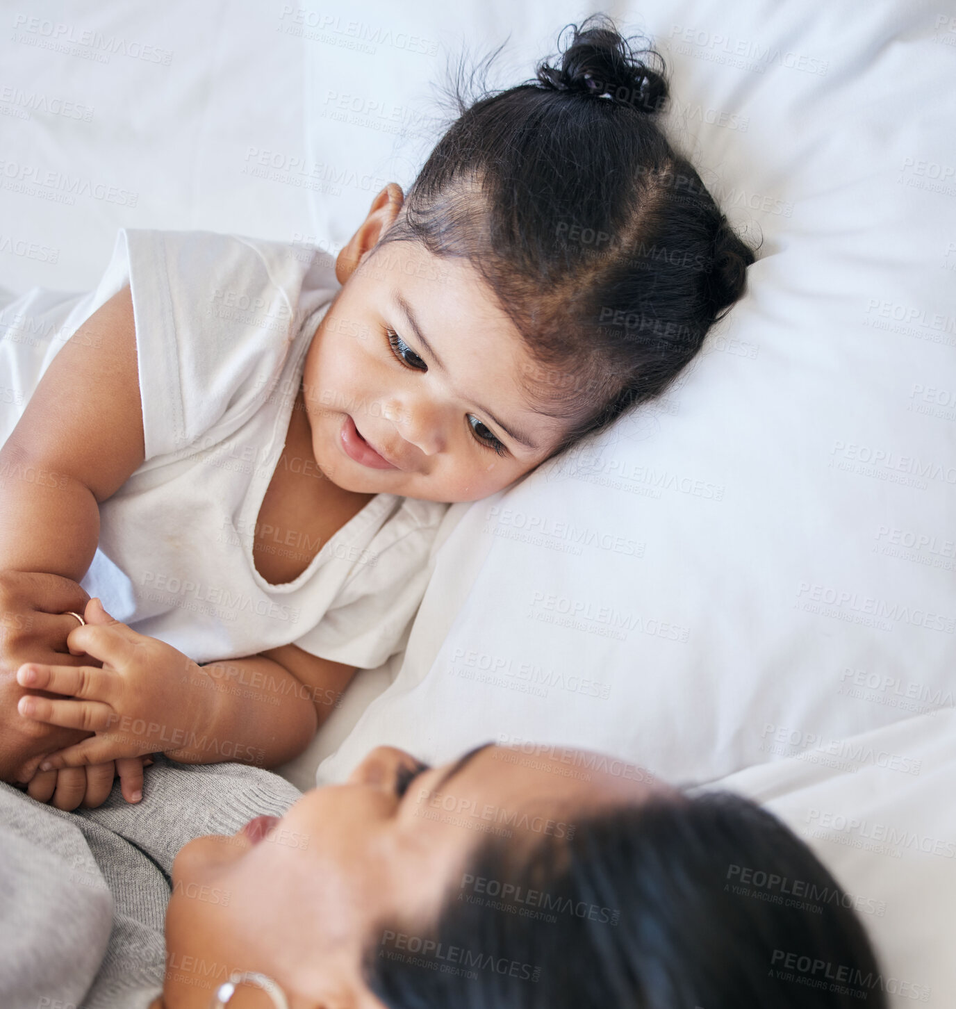 Buy stock photo Baby, mom love and girl in a bedroom bed with parent support and care with happiness. Morning, house and bonding together of a mother and child holding hands feeling happy from motherhood in a home