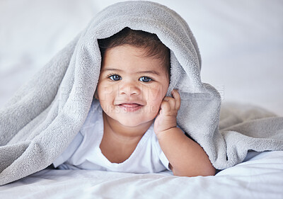 Buy stock photo Happy, comfy and portrait of a baby on a bed to relax, sleep and rest with a blanket. Smile, cute and adorable girl child lying in the bedroom for relaxation, comfort and happiness in a house