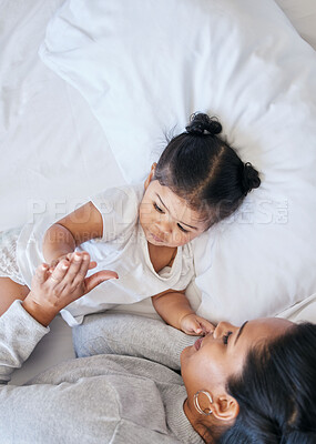 Buy stock photo Baby, mother care and girl in a bedroom bed with parent support and love with happiness. Morning, house and bonding together of a mom and child holding hands feeling happy from motherhood in a home