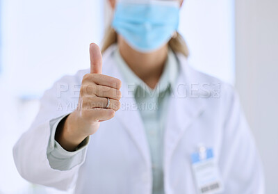 Buy stock photo Woman, doctor and hands in thumbs up for success, winning or good job with mask at the hospital. Hand of female medical professional showing thumb emoji, yes sign or like for life insurance at clinic