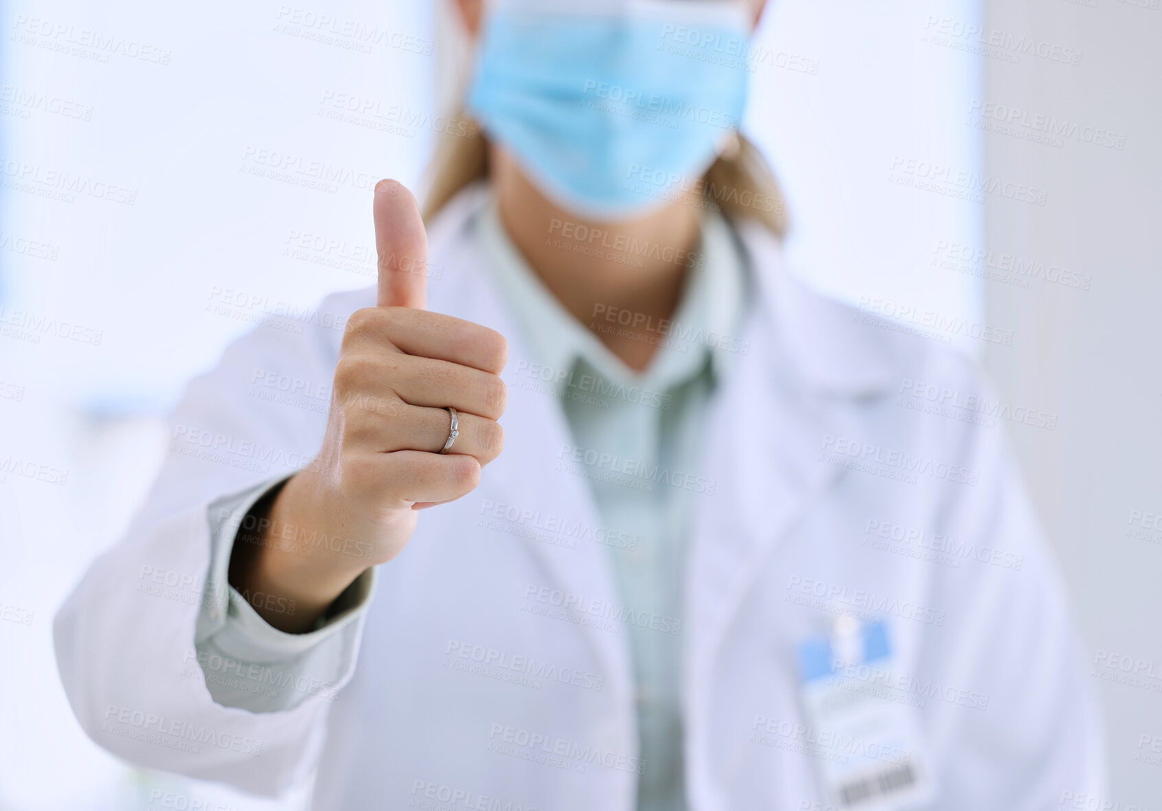 Buy stock photo Woman, doctor and hands in thumbs up for success, winning or good job with mask at the hospital. Hand of female medical professional showing thumb emoji, yes sign or like for life insurance at clinic