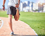 Wellness, man and stretching legs at beach promenade for exercise, fitness and training. Back of athlete, runner and person warm up body at seaside for summer workout, sports and marathon running