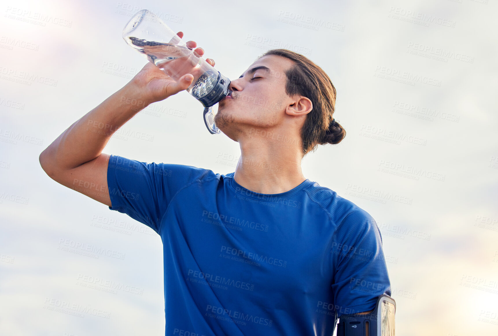 Buy stock photo Relax, drinking water and running with man in city for health, workout and marathon training. Fitness, mindset and summer with runner jogging in outdoors for hydration, energy and exercise wellness