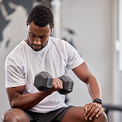 Black man, weight training and gym dumbbell of a athlete doing ...