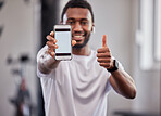 Phone screen, mockup and black man with thumbs up in gym for exercise or fitness. Sports, portrait and male athlete with smartphone for branding, advertising or marketing with hand emoji for success.