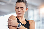 Shoulder pain, fitness and woman with injury in gym after accident, workout or training. Sports, health or young female athlete with fibromyalgia, inflammation or arthritis, tendinitis or painful arm